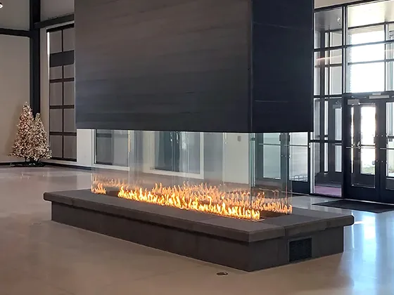 Modern commercial fireplace with a sleek design and beautiful glass flames.