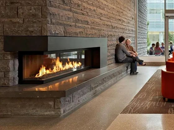 Modern commercial fireplace in a stylish lounge setting, providing warmth and ambiance for guests.