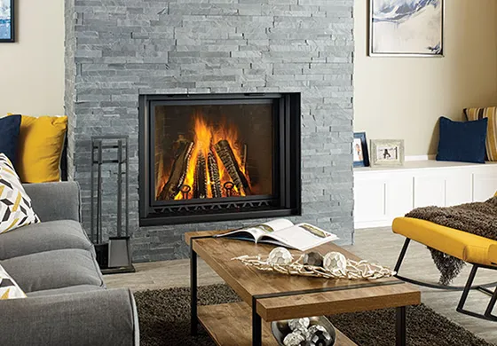 Beautiful living room featuring a modern residential fireplace with stone surround and warm flames.